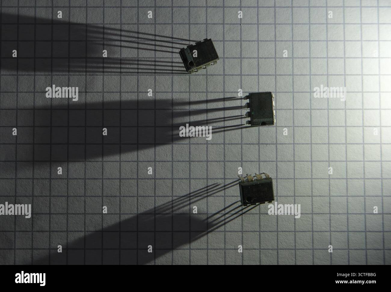 Integrated circuits and shadows in front of the light source. Stock Photo