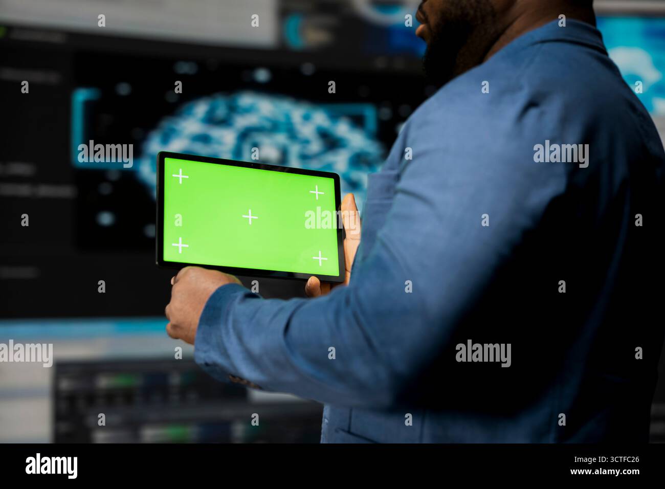 African American expert holds device with mockup screen with binary code in the background, digital transformation. Showcasing software development with algorithms, data science. Stock Photo