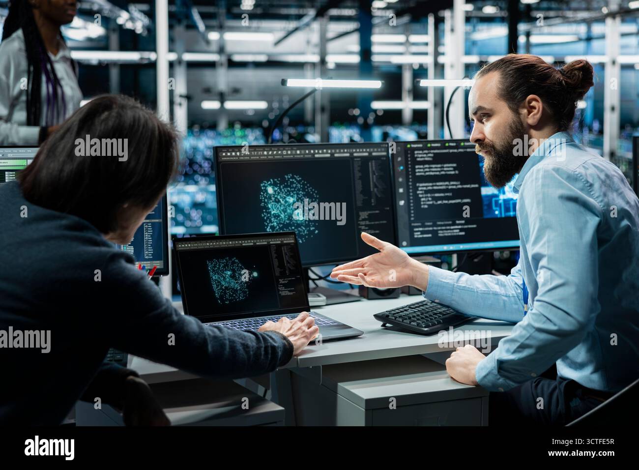 Team of data center admins working on databases supporting AI apps. Teamworking server room colleagues using artificial intelligence technology to do algorithms improvements Stock Photo