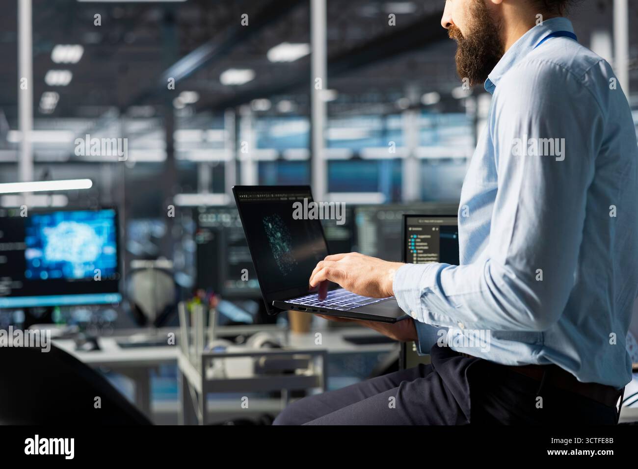 Programmer coding in high tech data center office, updating AI automation scripts. Server room employee programming artificial intelligence algorithms, debugging equipment racks Stock Photo