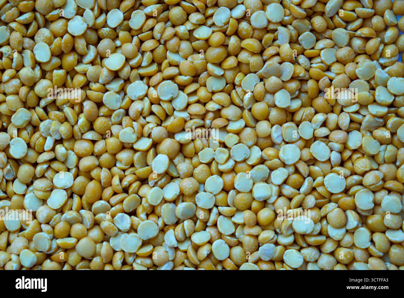 Dry split yellow peas scattered all around the perimeter of the photo Stock Photo
