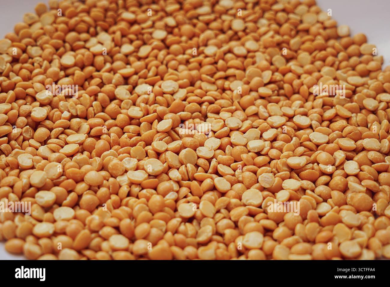 Dry split yellow peas in the big plastic bowl Stock Photo