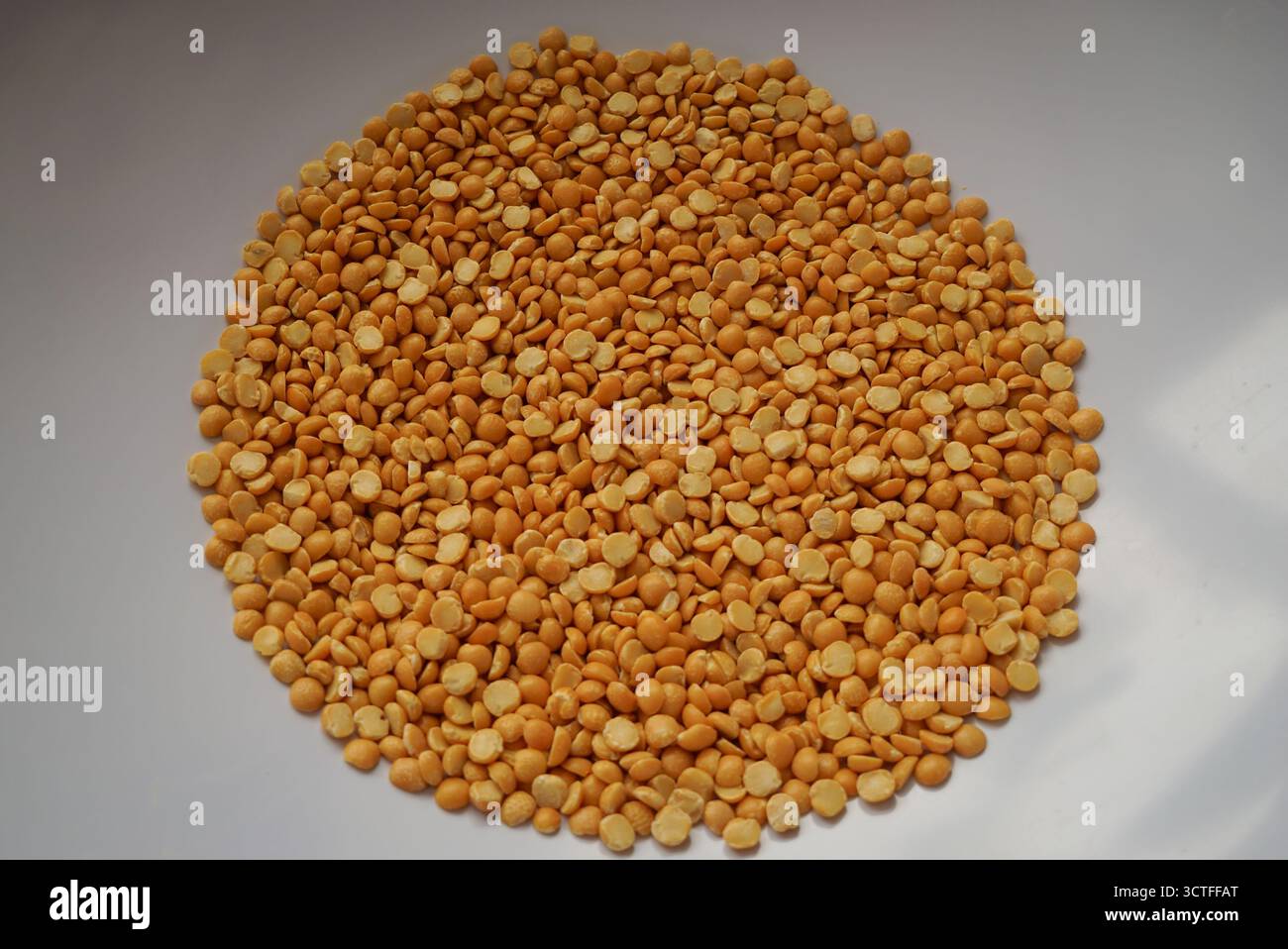 Dry split yellow peas in the big plastic bowl Stock Photo