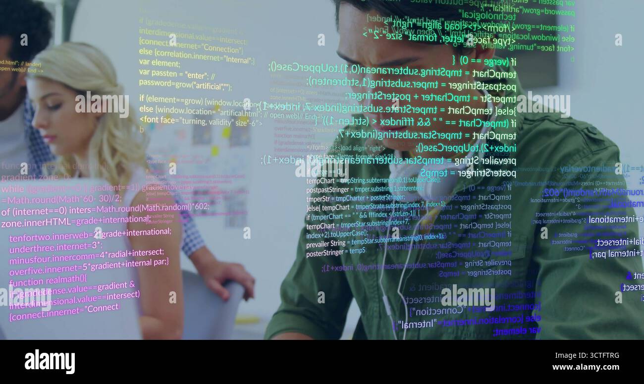 Coding developer wearing green shirt and earbuds at tech office desk, with laptop notes, copy space Stock Photo