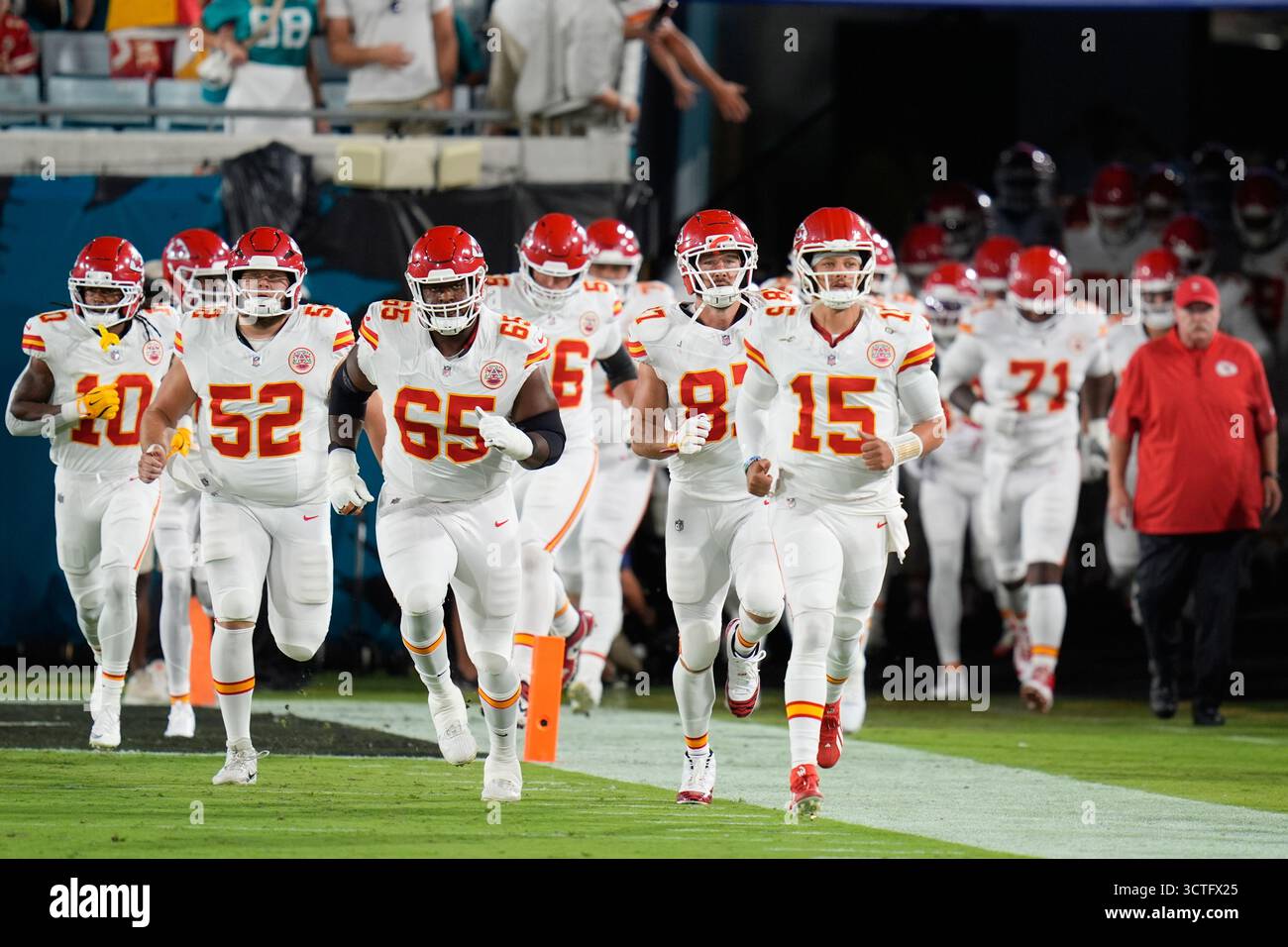 Kansas City Chiefs players run onto the field before an NFL football ...