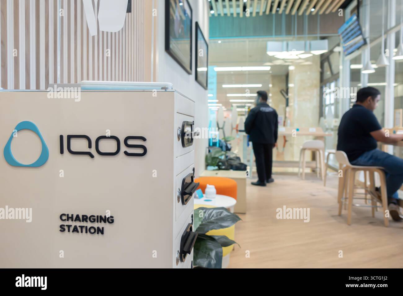 Iqos e-cigarettes sponsored charging station for smartphones, mobile devices, electronics, USB ports at Manila airport, Philippines Stock Photo