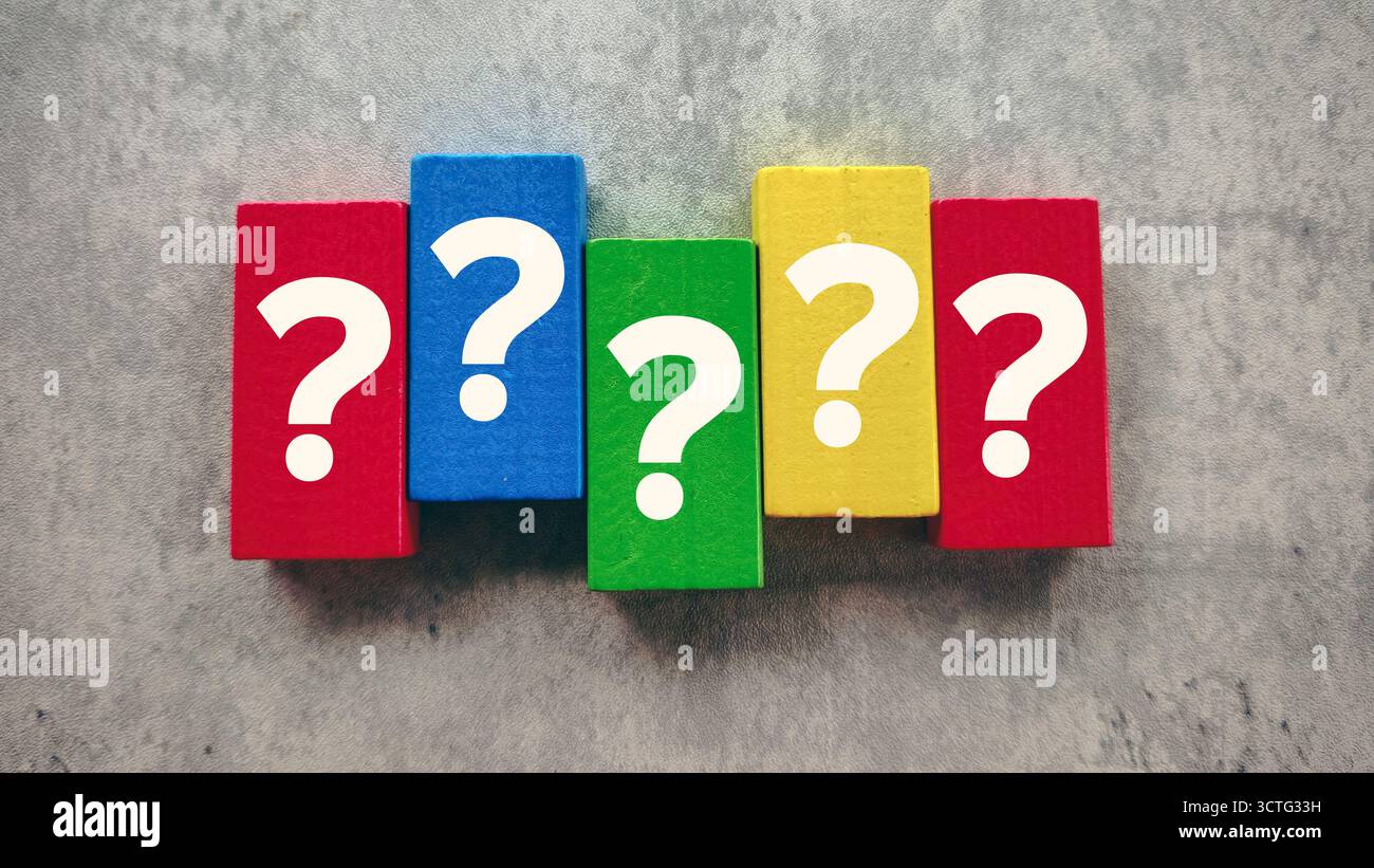 Vibrant Question Marks on Colorful Wooden Blocks on a Grey Background Representing Problem Solving and Doubt Stock Photo
