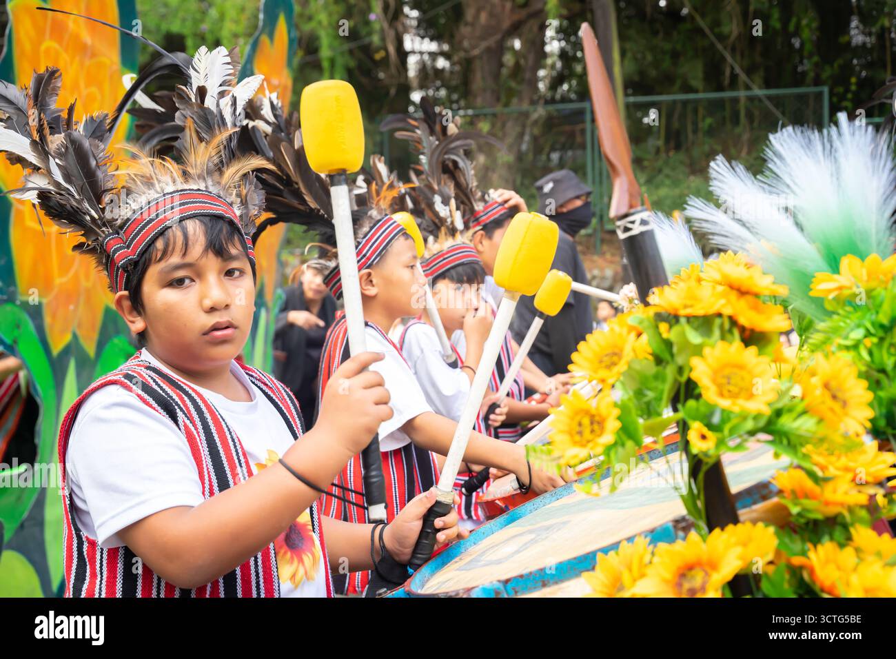 Teenagers in traditional costumes playing drums, performance during the Panagbenga Festival in Baguio City, Philippines Stock Photo