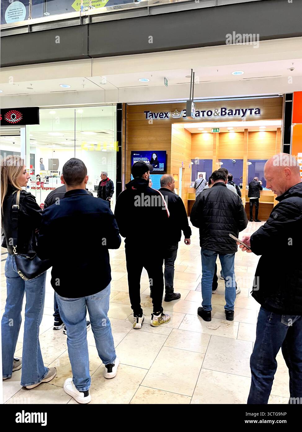 People queue at Tavex exchange office in Sofia Bulgaria shopping centre, ahead of the upcoming Euro adoption in Bulgaria, Eastern Europe, Balkans, EU - Smartphone Captured Stock Image