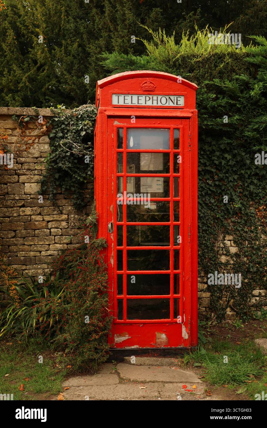British red telephone box, an iconic symbol, standing beside an old ...