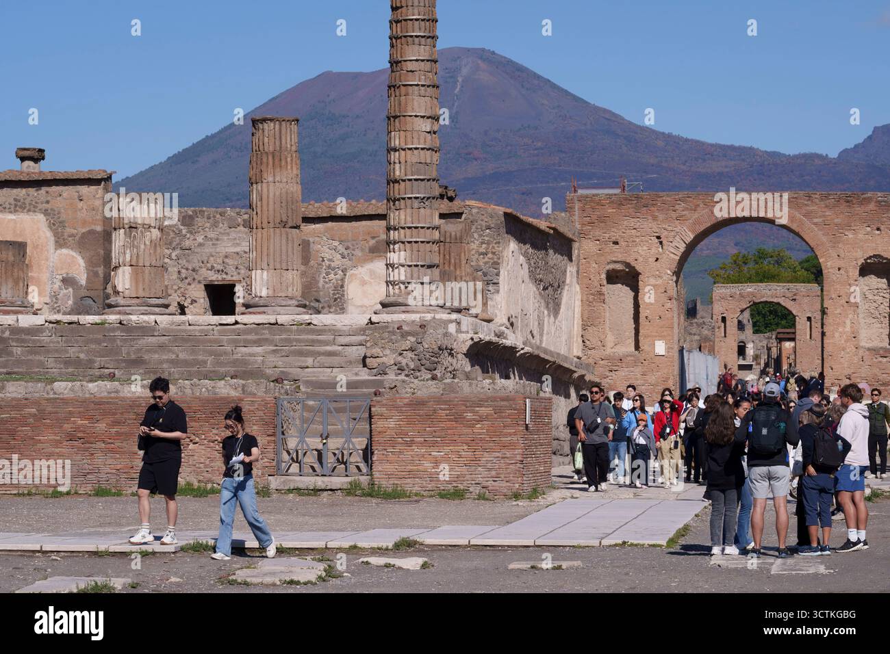 Tourists and tour groups walk through the Forum in Pompeii, the former ...