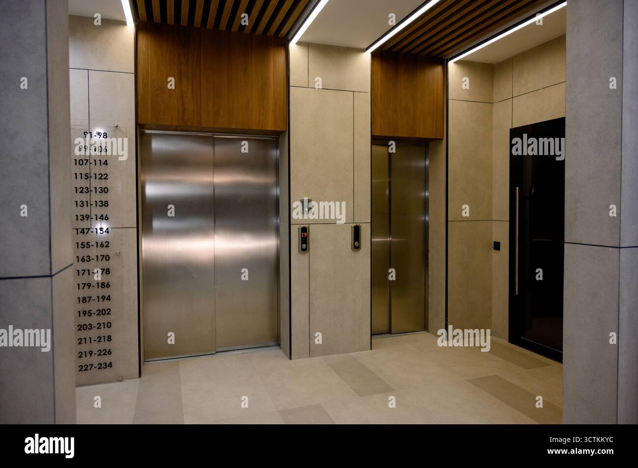 Interior of the lobby with metal elevators. A modern elevator hall of a ...