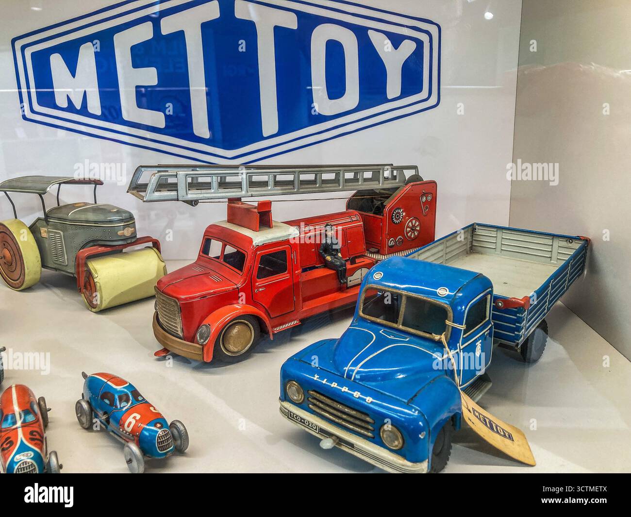 Display case showing early products from Mettoy, a British manufacturing company which made tinplate toys in the 1930's - Smartphone Captured Stock Image