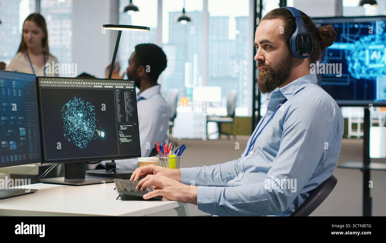 Software developer coding with AI language model assistance in office, listening music. Programmer wearing headphones integrating LLM assistant suggestions into code editor, camera A Stock Photo