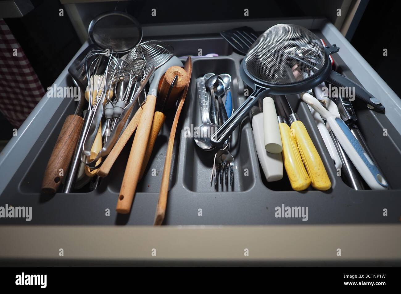 Kitchen drawer with various cooking utensils and tools Stock Photo