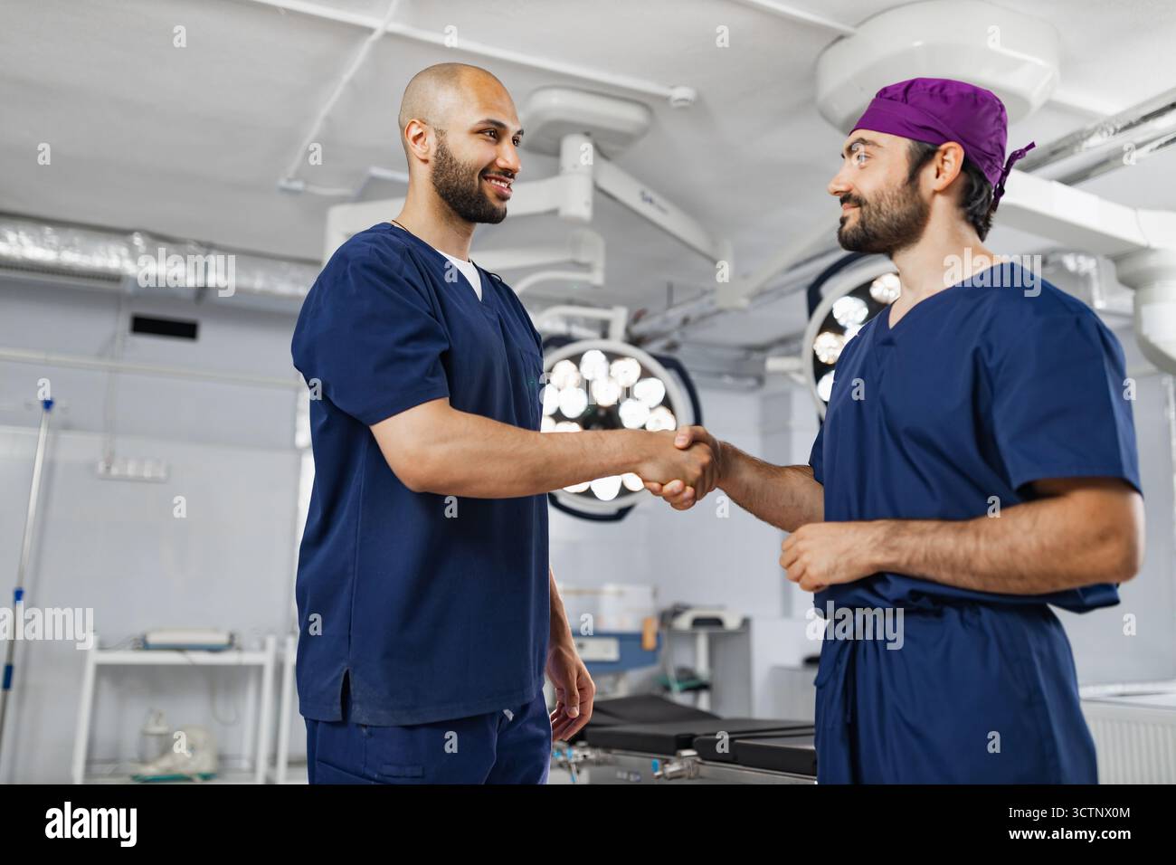 Surgeons Handshake in Operating Room Stock Photo
