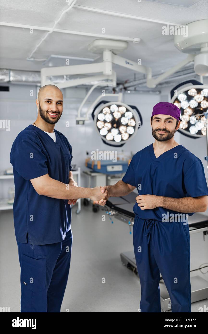 Surgeons Handshake in Operating Room Stock Photo