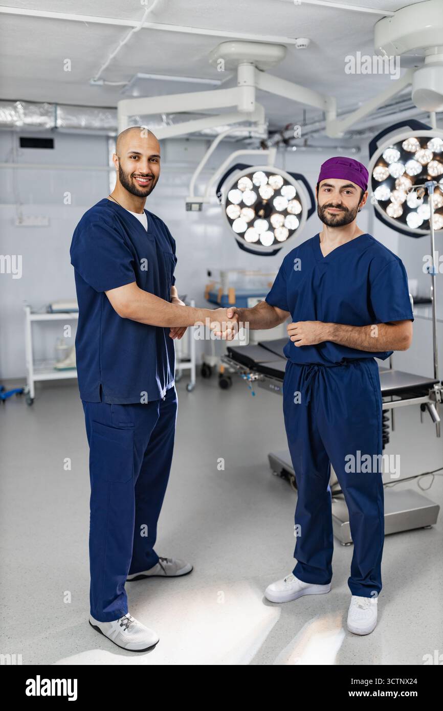 Surgeons Handshake in Operating Room Stock Photo