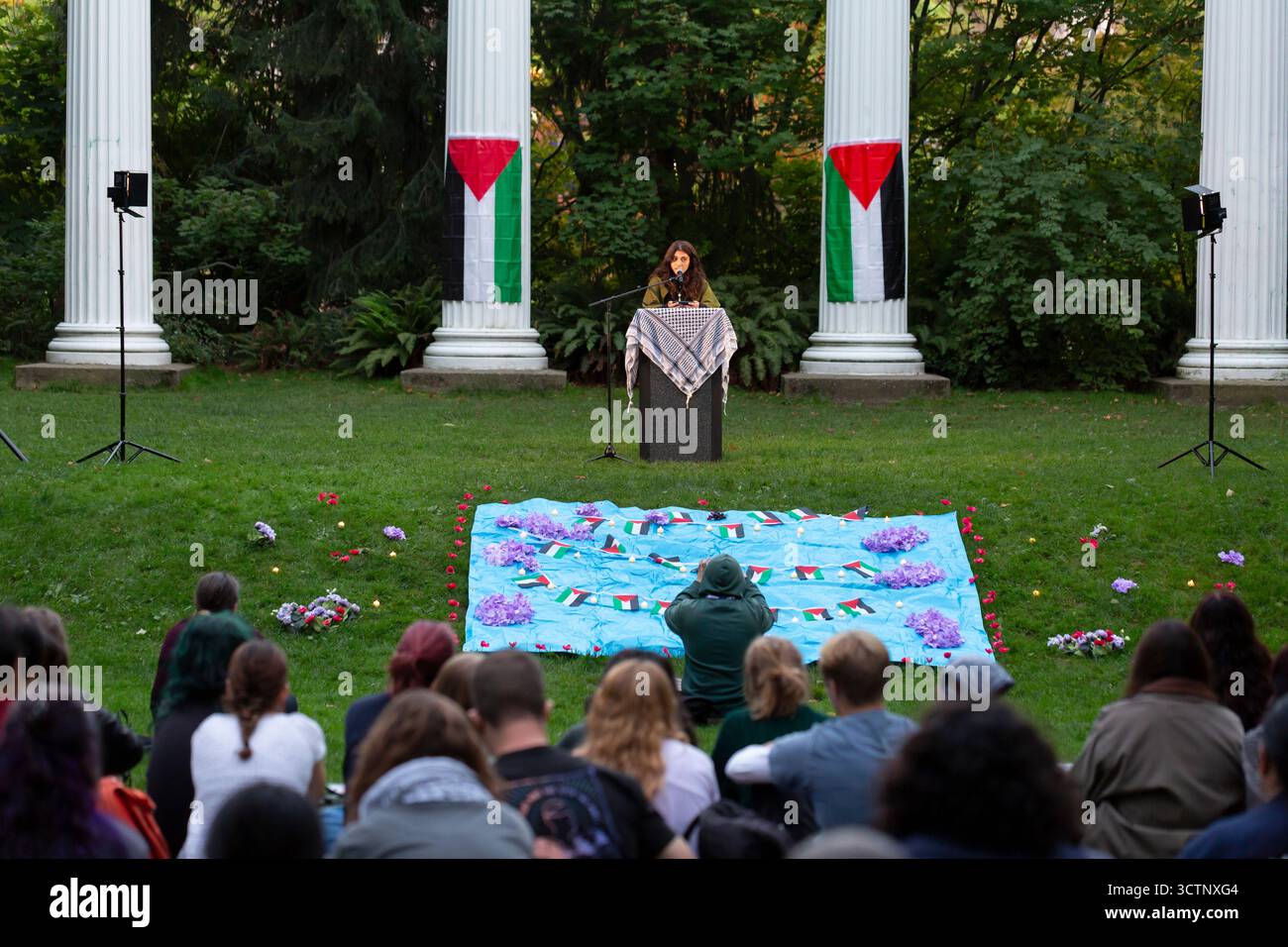 Seattle, Washington, USA. 7th October 2025. Tamara, a member of Zaytoon, speaks at a Vigil for Palestine honoring lives lost on the two-year anniversary of Hamas’ Oct. 7 attack at the University of Washington. The vigil and prayer were organized by Zaytoon UW, a Palestinian led organization at the University of Washington. Credit: Paul Christian Gordon/Alamy Live News Stock Photo