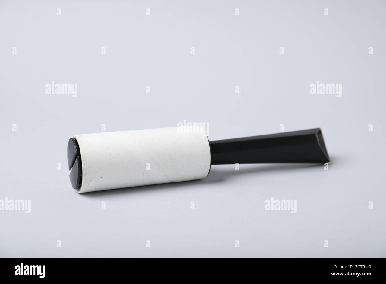 One lint roller on light grey background Stock Photo