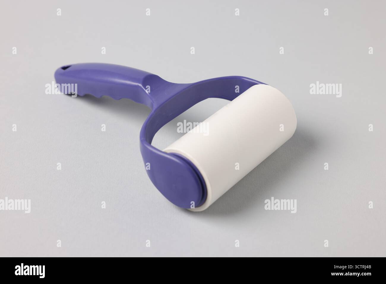 One lint roller on light grey background, closeup Stock Photo