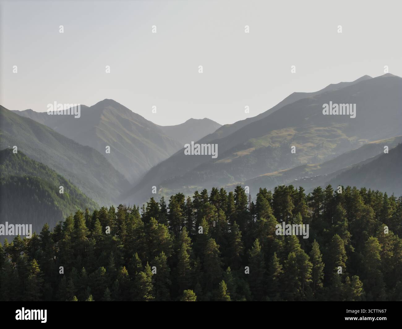 Aerial view of dramatic mountain ranges layered in hazy blues and ...