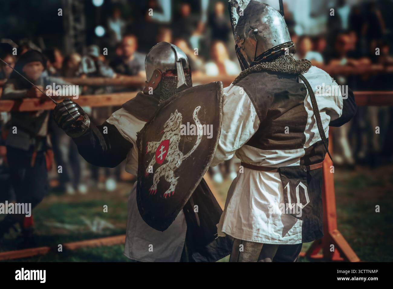 The photo shows two armored knights participating in a medieval battle ...