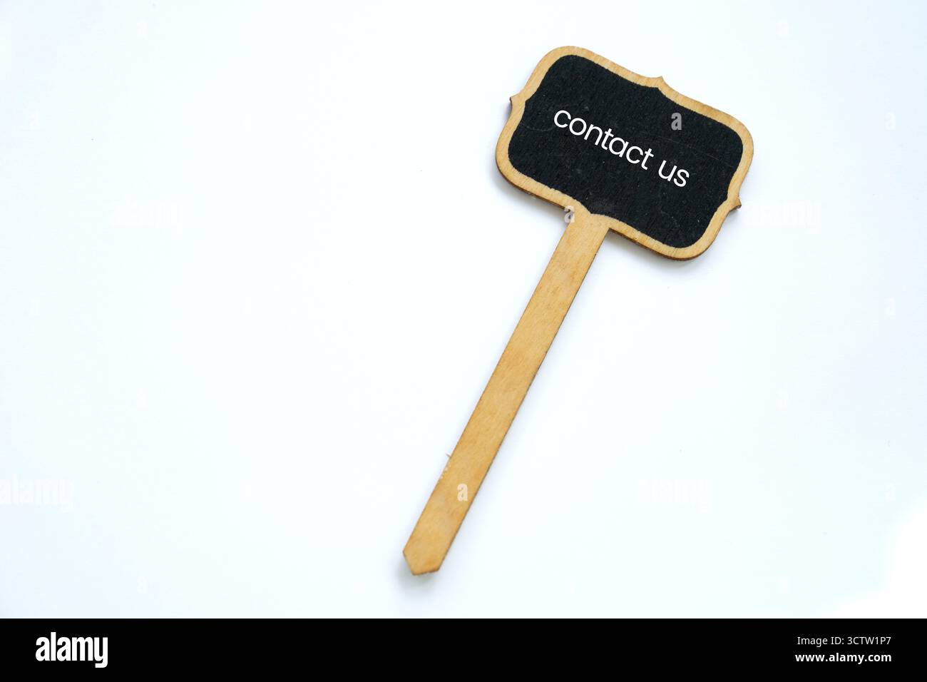 A small Contact Us note on blackboard on white background Stock Photo