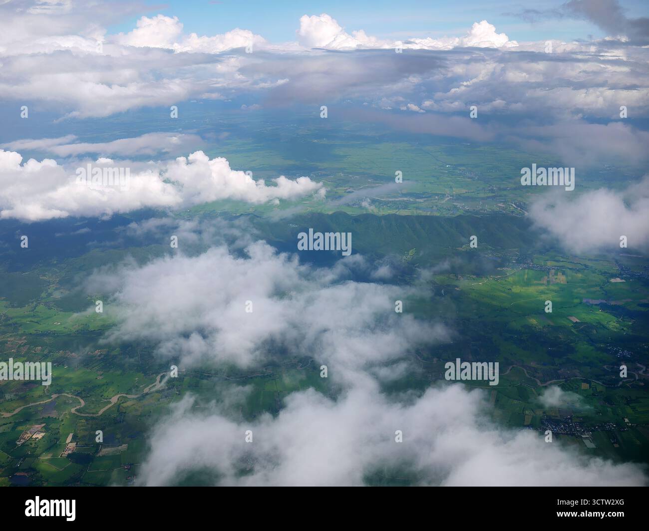 Aerial view of tranquil fluffy clouds in the blue sky with landscape ...