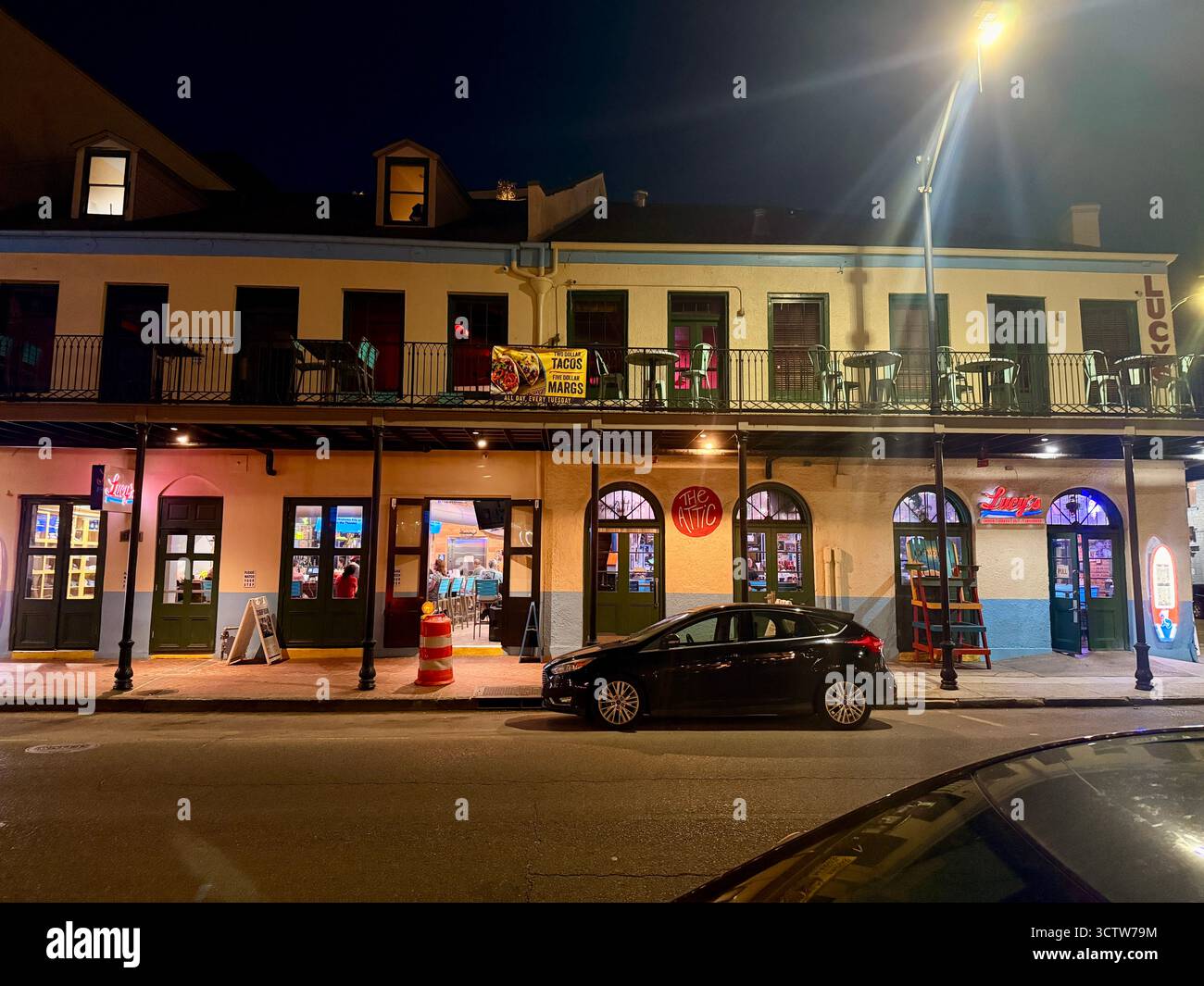 Night street view with bars and balconies in the French Quarter, New Orleans - Smartphone Captured Stock Image