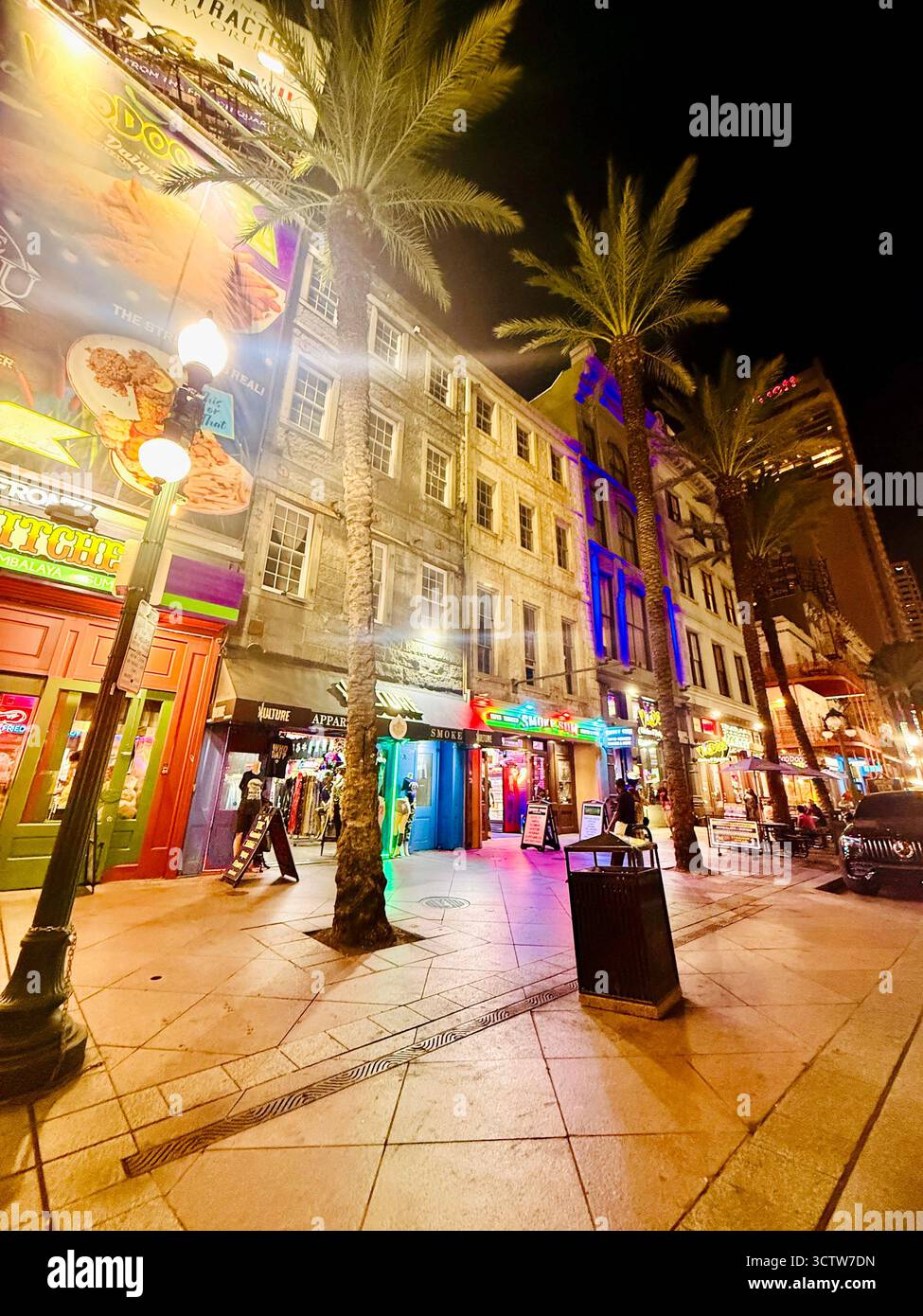 Colorful night street with neon lights and palm trees in downtown New Orleans - Smartphone Captured Stock Image