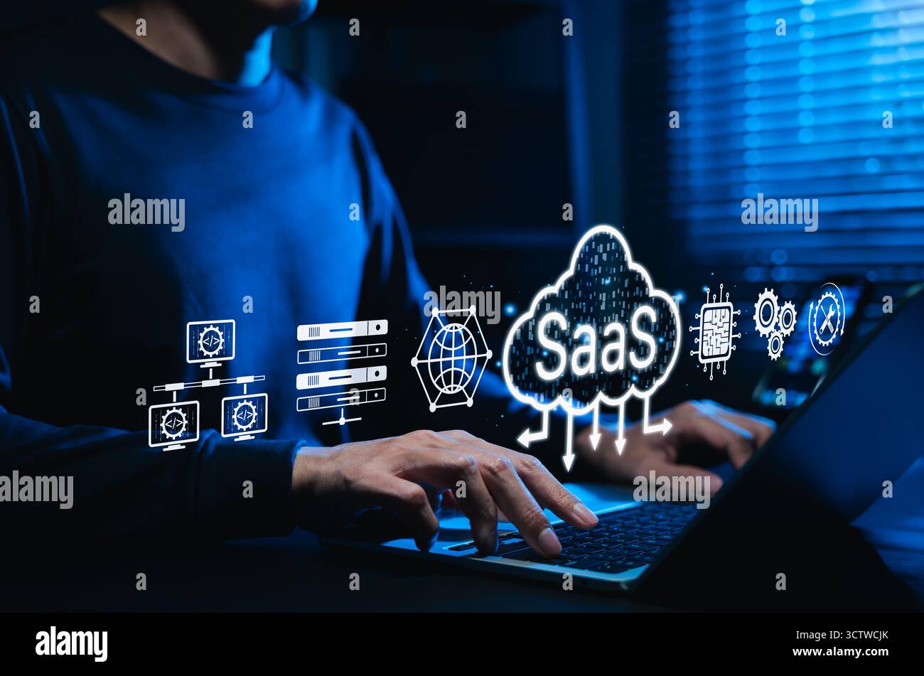 SaaS cloud computing and software service technology. Man using laptop with SaaS and cloud icon, represent Software as a Service, cloud infrastructure Stock Photo