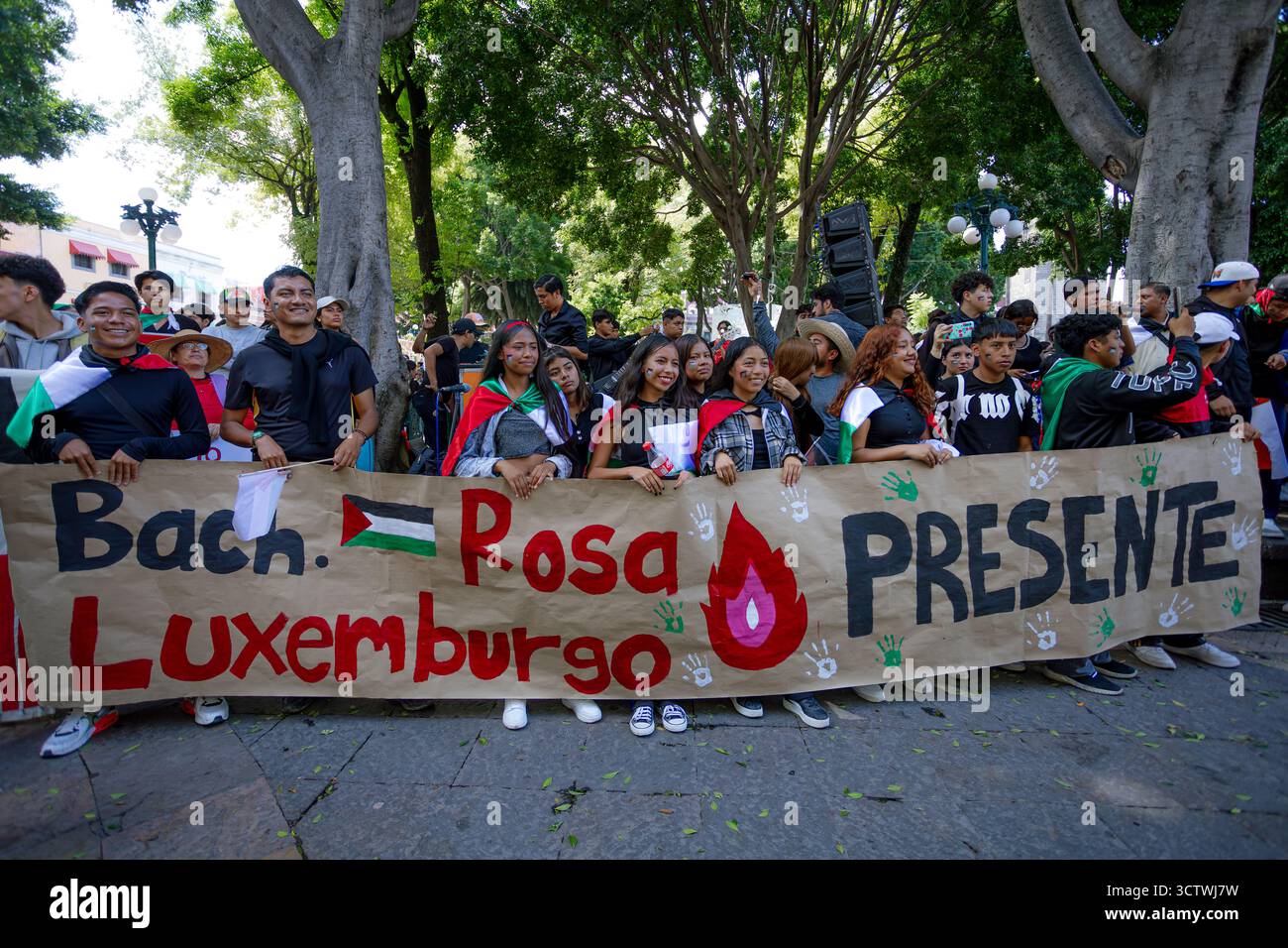Group of students in Puebla march with signs and Palestinian flags ...
