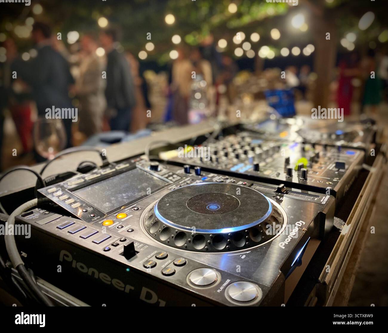 DJ Equipment with Pioneer Controller and Party Atmosphere at Celebration Event - Smartphone Captured Stock Image