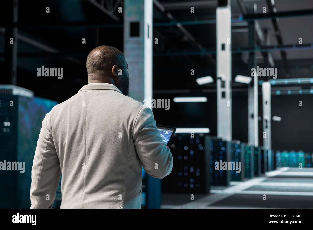 Server hub software developer uses machine learning on device to predict future gear needs. Data center computer scientist using AI neural networks tech on tablet to enhance operational effectiveness. Stock Photo