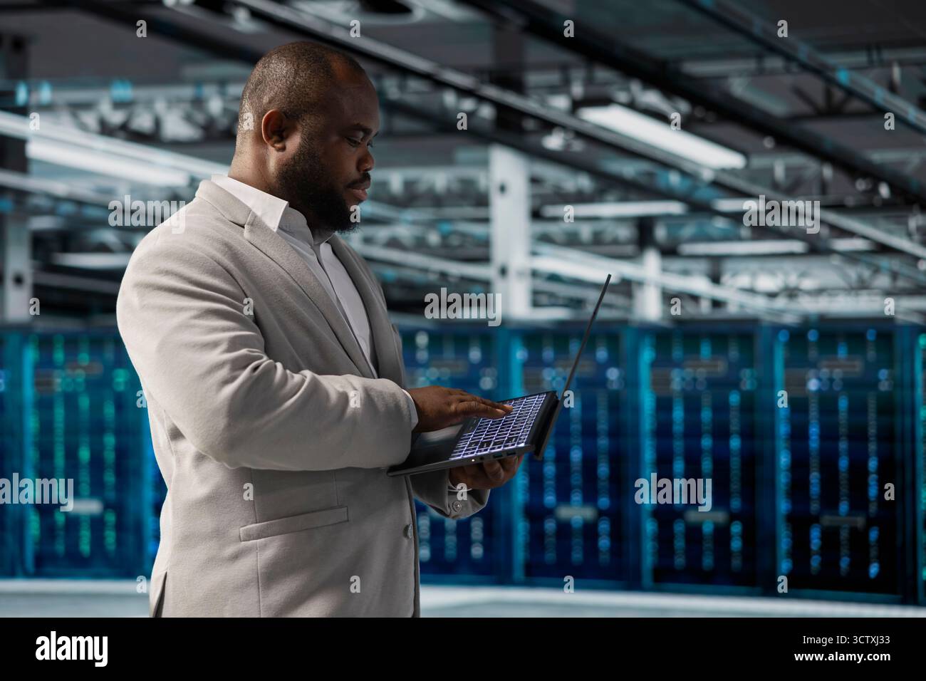 Data center employee running predictive maintenance scans, fixing network issues affecting rigs performance. Technician running system diagnostic tests, tracking resource utilization Stock Photo