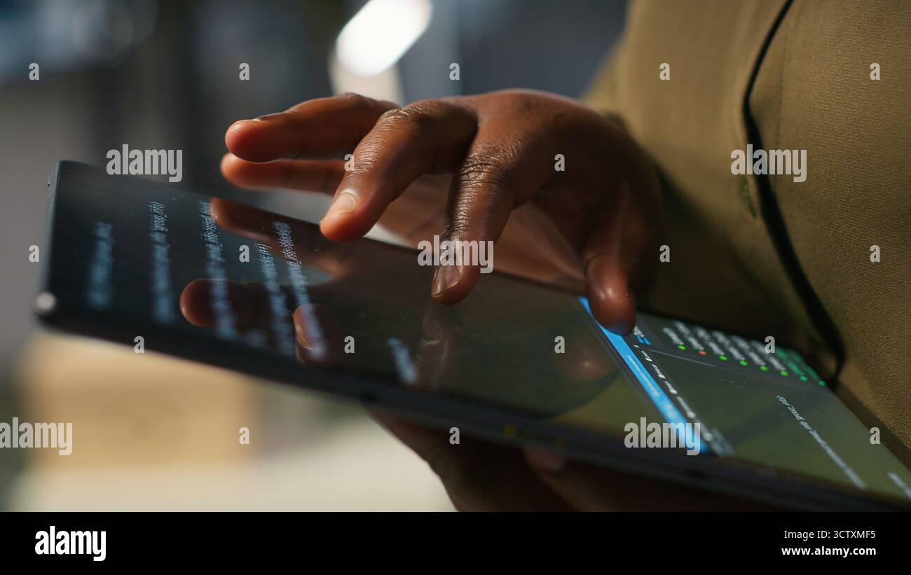 Close up of programmer utilizing AI on tablet to optimize performance and forecast issues. System administrator in office training machine learning models using device, camera A Stock Photo