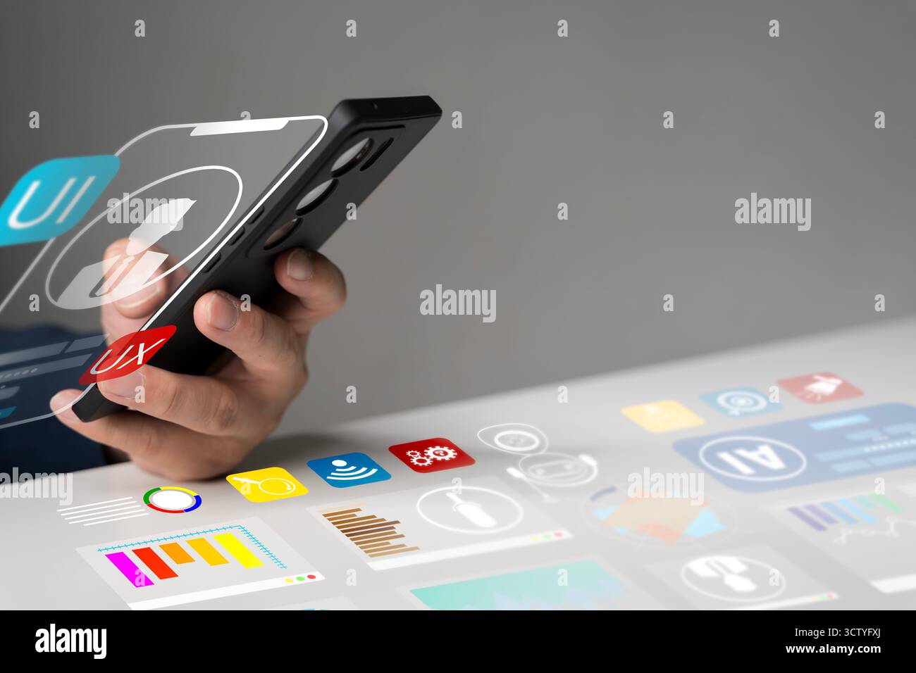 Hand holding smartphone with digital interface showing UI UX design, data analytics, and AI technology concept, representing mobile app development, i Stock Photo