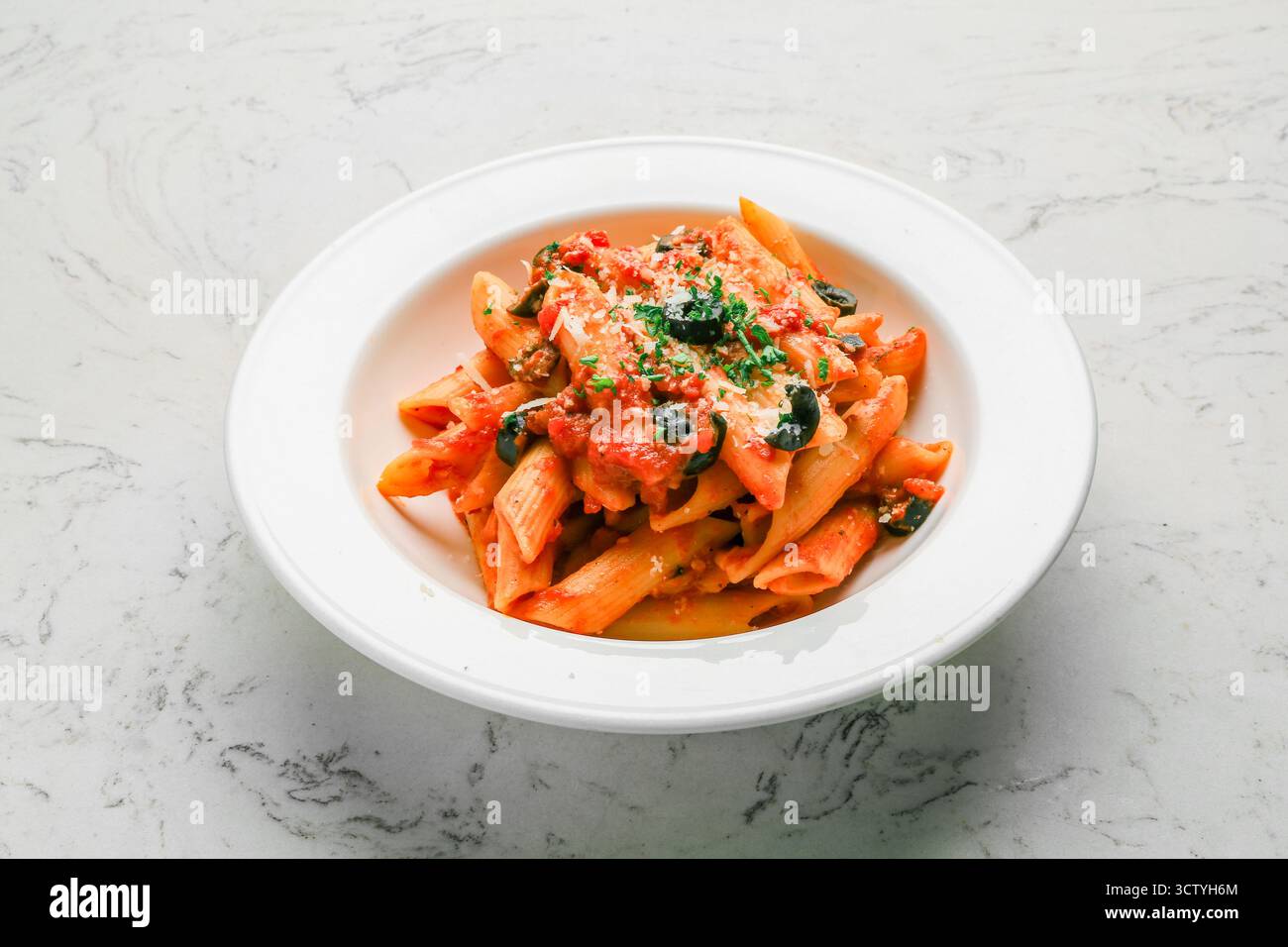 Penne Pomodoro Tomato Sauce, Fresh Basil, Black Olives, and Parmesan Pasta Stock Photo