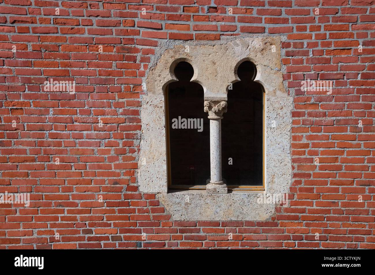 Stone window on the brick wall Stock Photo