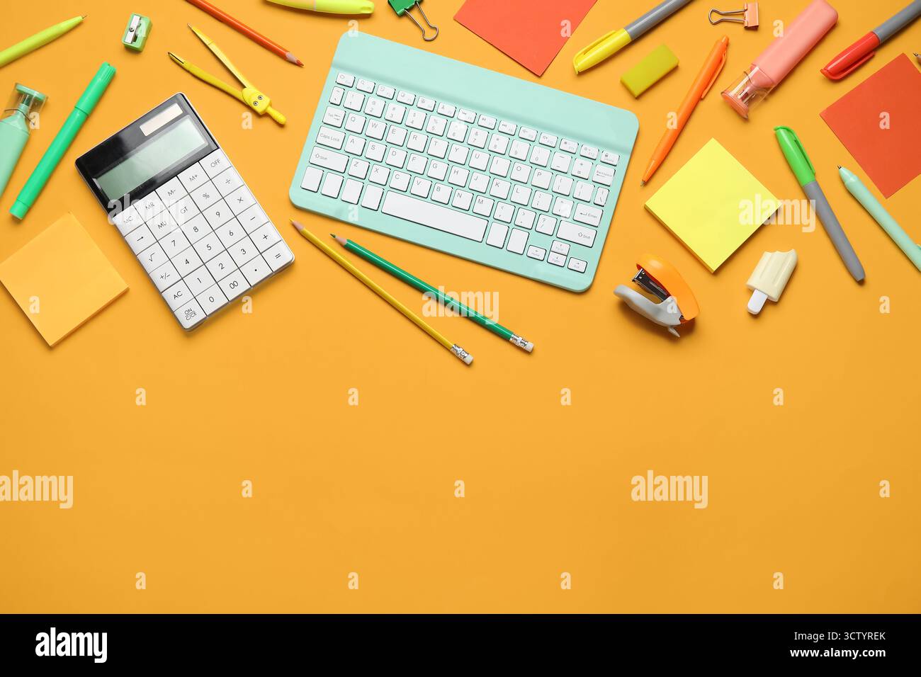 Composition with modern computer keyboard and different stationery on orange background Stock Photo