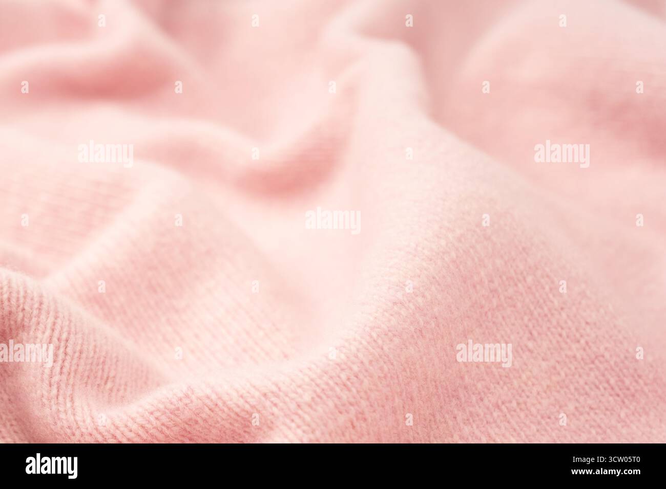 Soft pink cashmere sweater texture background. Top view. Stock Photo
