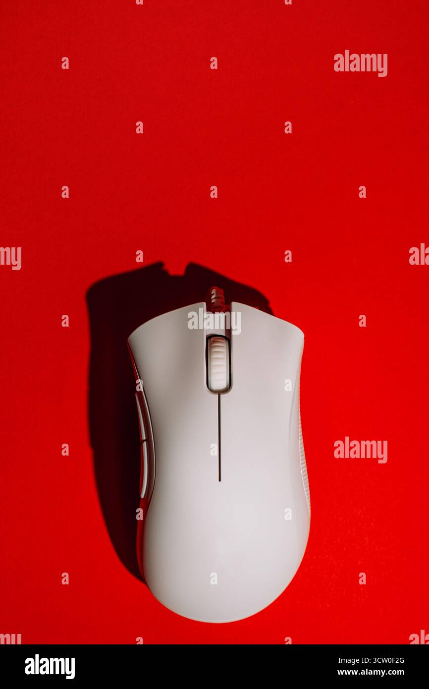 White wired gaming mouse on red background top view Stock Photo