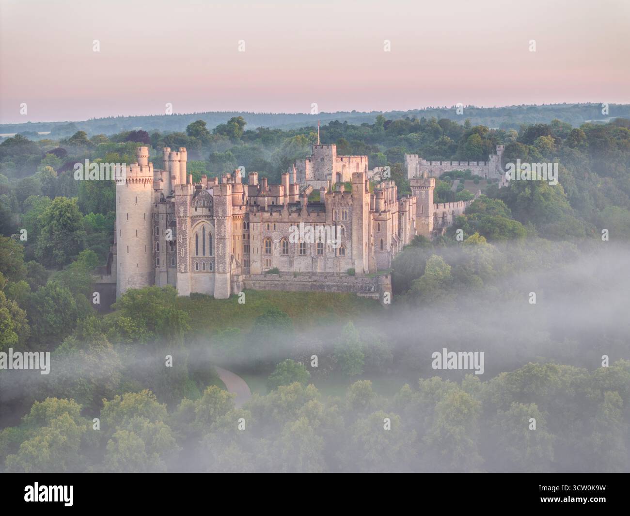 Aerial view of Arundel Castle at dawn on a misty morning, West Sussex, England.  Summer (July) 2024. Stock Photo