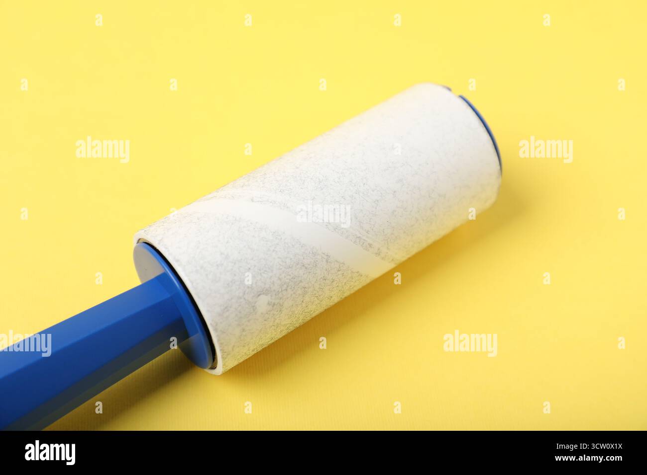 One lint roller on yellow background, closeup Stock Photo