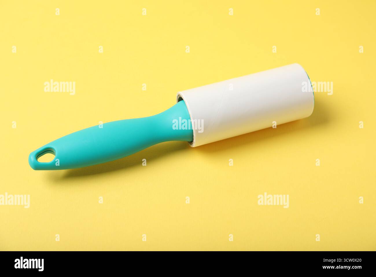 One lint roller on yellow background, closeup Stock Photo