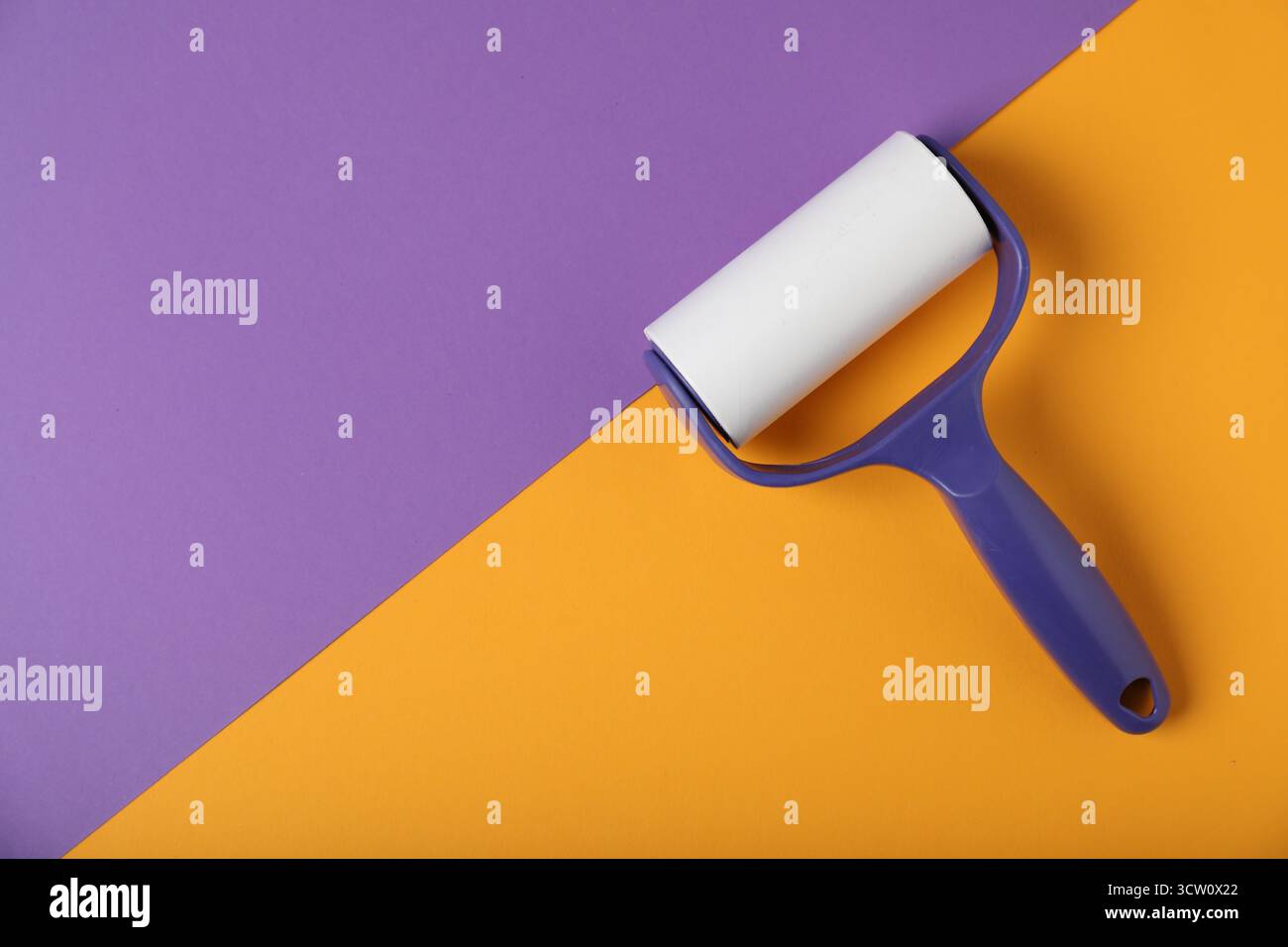 One lint roller on color background, top view. Space for text Stock Photo