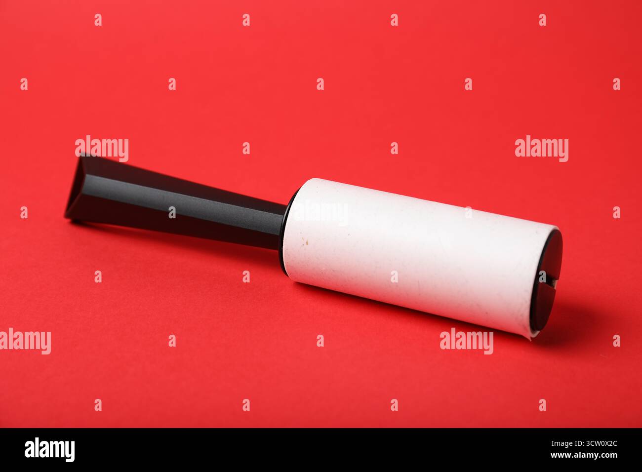 One lint roller on red background, closeup Stock Photo