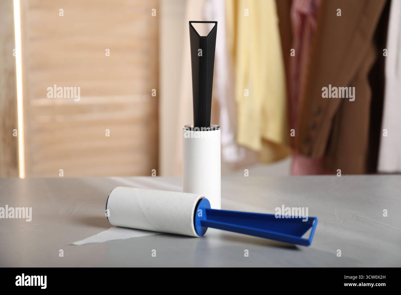 Lint rollers on grey table indoors, closeup Stock Photo