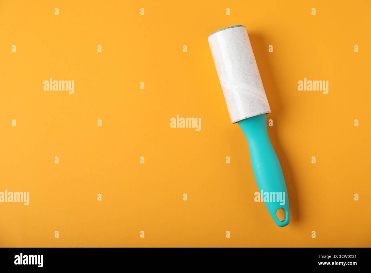 One lint roller on orange background, top view. Space for text Stock Photo